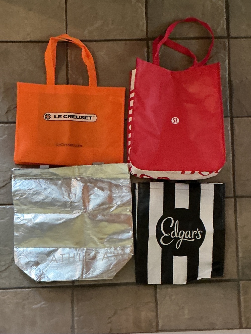 Assorted shopping bags-Athleta, Lululemon, Edgar’s, Le Creuset